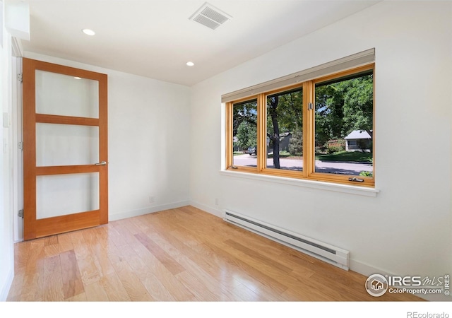 600 Monte Vista Ave, Fort Collins, CO 80521 - spare room with a baseboard heating unit, light wood-type flooring, and recessed lighting