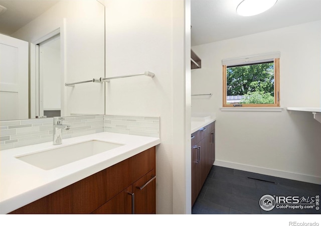600 Monte Vista Ave, Fort Collins, CO 80521 - bathroom with vanity, decorative backsplash, and tile patterned floors