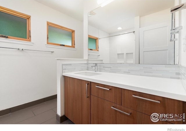 600 Monte Vista Ave, Fort Collins, CO 80521 - bathroom featuring vanity, tasteful backsplash, and tile patterned floors