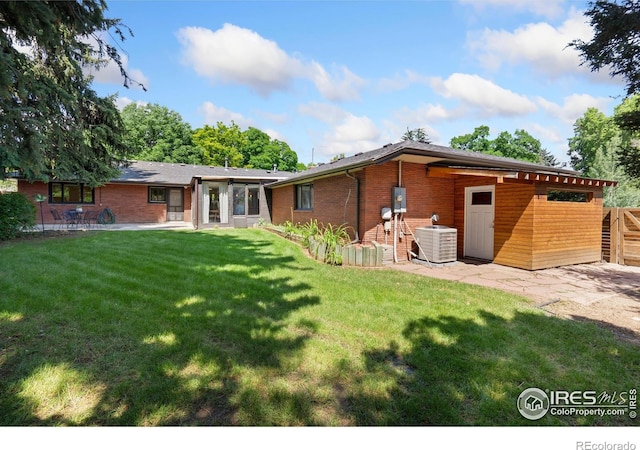 600 Monte Vista Ave, Fort Collins, CO 80521 - rear view of property featuring a patio area, a lawn, and brick siding