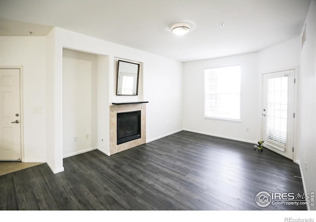 3155 Blue Sky Cir Unit 16-103, Erie, CO 80516 - unfurnished living room with a fireplace and dark wood-style flooring