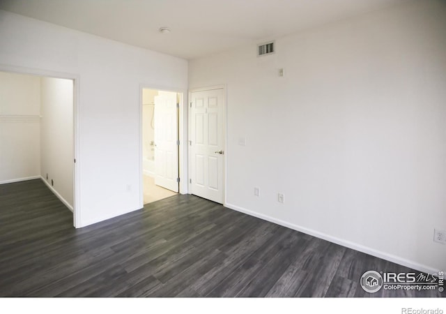 3155 Blue Sky Cir Unit 16-103, Erie, CO 80516 - unfurnished bedroom with dark wood finished floors, a spacious closet, a closet, and ensuite bath