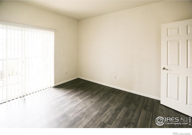 3155 Blue Sky Cir Unit 16-103, Erie, CO 80516 - unfurnished bedroom featuring dark wood-style floors and baseboards