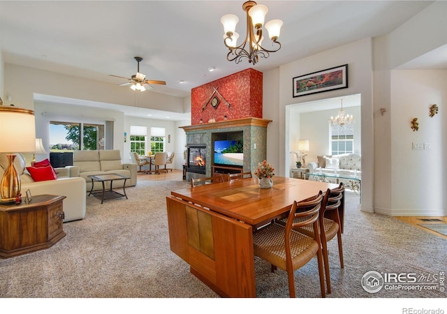 8305 E 149th Dr, Thornton, CO 80602 - living room with a chandelier, carpet floors, a glass covered fireplace, a ceiling fan, and recessed lighting
