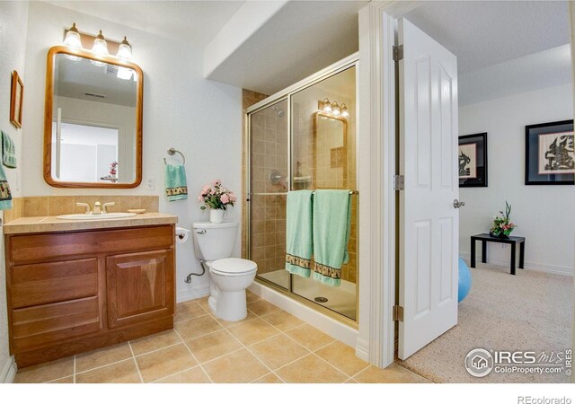 8305 E 149th Dr, Thornton, CO 80602 - full bath featuring vanity, a shower stall, and tile patterned floors