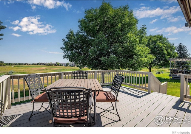 8305 E 149th Dr, Thornton, CO 80602 - wooden deck featuring outdoor dining space and a yard