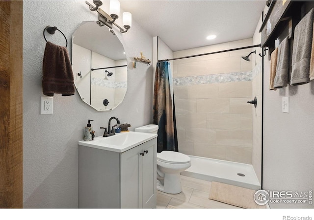 4521 Mesa Verde Dr, Greeley, CO 80634 - bathroom with vanity, a tile shower, a textured wall, and tile patterned flooring