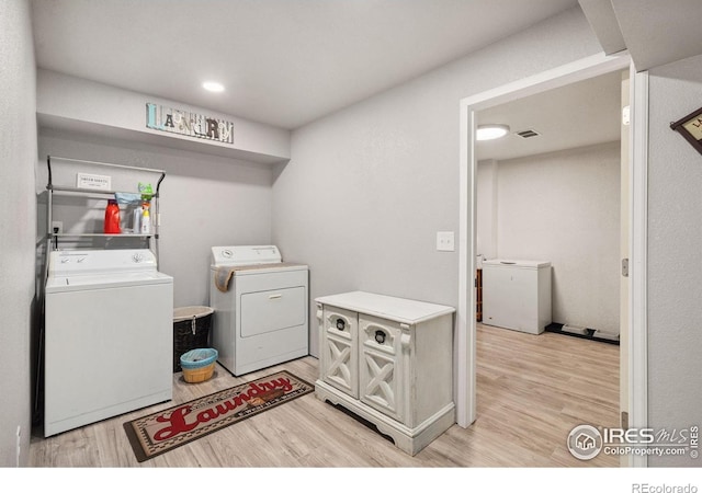 4521 Mesa Verde Dr, Greeley, CO 80634 - laundry area featuring washing machine and dryer and light wood-style flooring