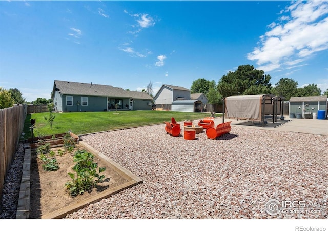 4521 Mesa Verde Dr, Greeley, CO 80634 - fenced backyard featuring a storage unit and a vegetable garden