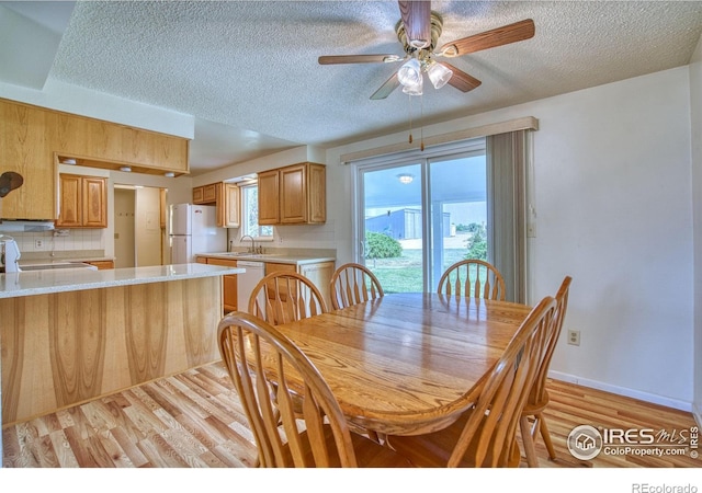 13600 Elmore Rd, Longmont, CO 80504 - dining space with a textured ceiling, light wood-style floors, and ceiling fan