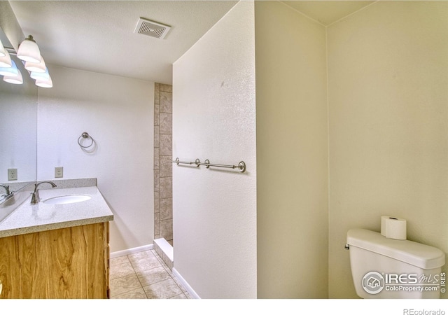 13600 Elmore Rd, Longmont, CO 80504 - full bathroom with vanity, tile patterned flooring, and a tile shower