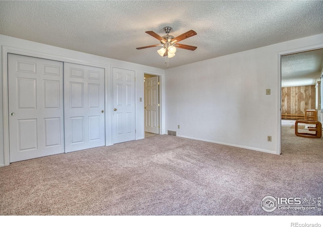 13600 Elmore Rd, Longmont, CO 80504 - unfurnished bedroom with carpet flooring, a textured ceiling, a closet, and a ceiling fan