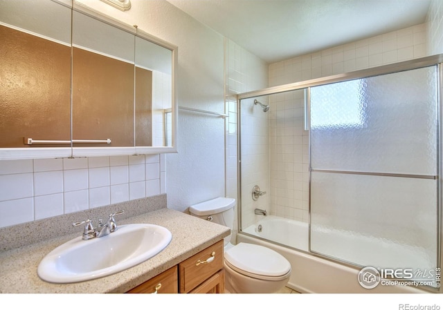 13600 Elmore Rd, Longmont, CO 80504 - full bath with vanity, bath / shower combo with glass door, a textured wall, and tasteful backsplash