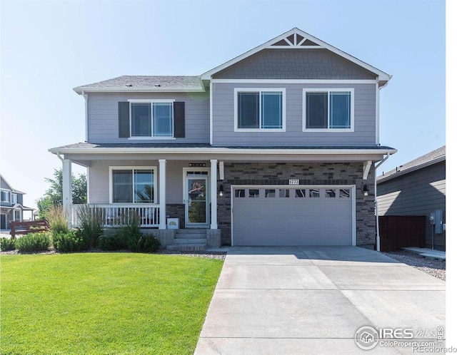 1773 Nightfall Dr, Windsor, CO 80550 - craftsman-style house with a garage, a front yard, covered porch, concrete driveway, and stone siding