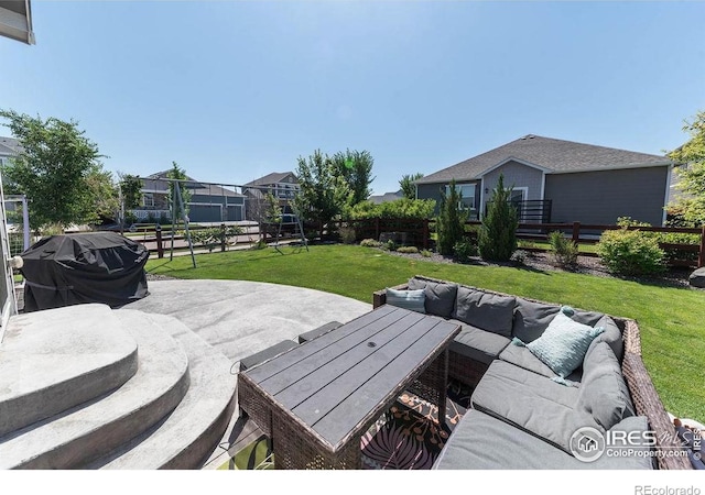 1773 Nightfall Dr, Windsor, CO 80550 - fenced backyard with a grill, a patio area, and an outdoor hangout area