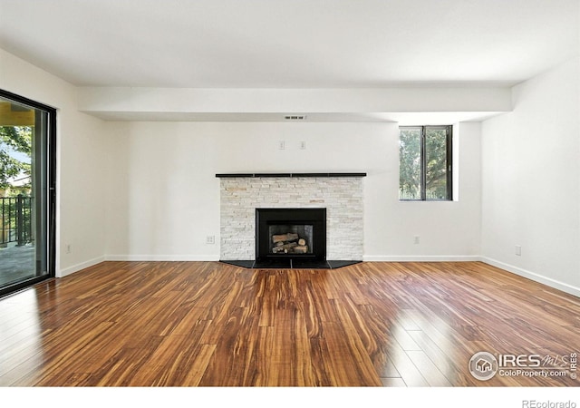 600 Manhattan Dr Unit B7, Boulder, CO 80303 - unfurnished living room featuring wood-type flooring and a stone fireplace