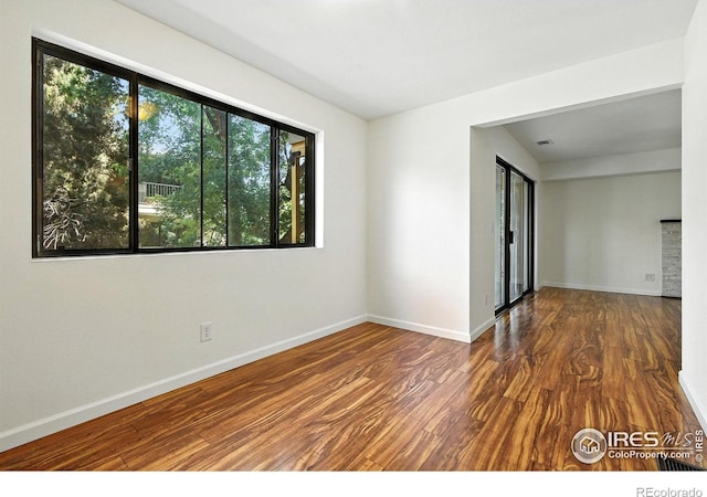 600 Manhattan Dr Unit B7, Boulder, CO 80303 - spare room with wood finished floors and baseboards