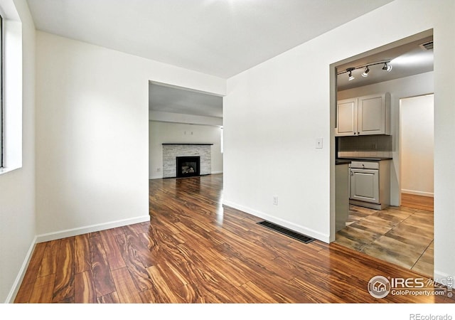 600 Manhattan Dr Unit B7, Boulder, CO 80303 - empty room featuring wood finished floors and a fireplace with flush hearth