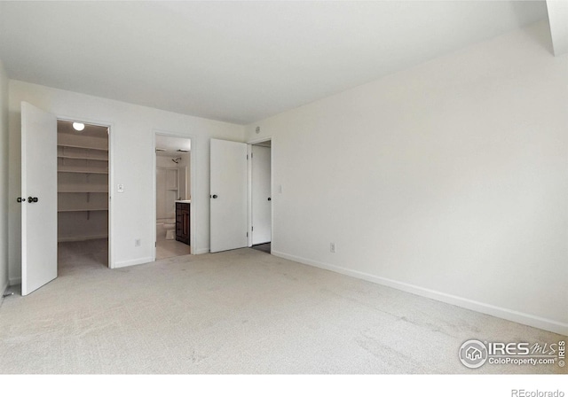 600 Manhattan Dr Unit B7, Boulder, CO 80303 - unfurnished bedroom with carpet flooring, a walk in closet, a closet, and connected bathroom