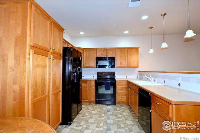 3641 29th St Unit 6, Greeley, CO 80634 - kitchen with black appliances, light countertops, pendant lighting, brown cabinetry, and recessed lighting