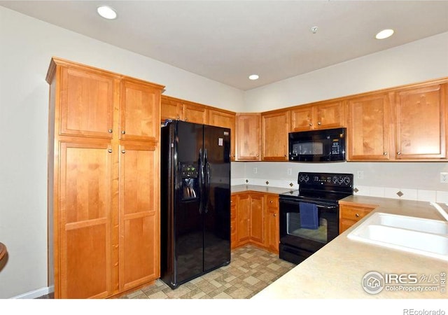 3641 29th St Unit 6, Greeley, CO 80634 - kitchen featuring black appliances, light countertops, brown cabinetry, recessed lighting, and light flooring