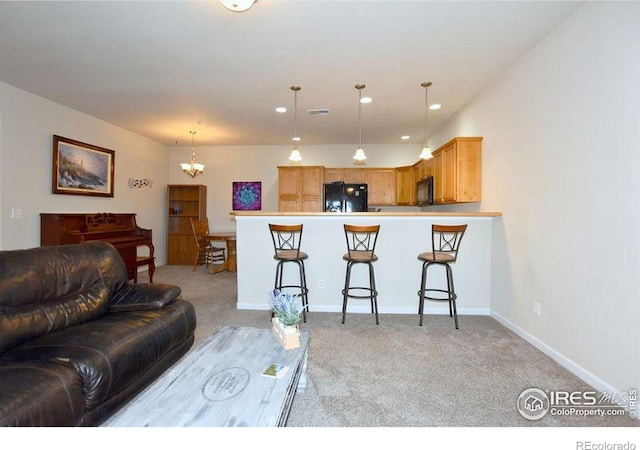 3641 29th St Unit 6, Greeley, CO 80634 - living area with light colored carpet, recessed lighting, and a chandelier