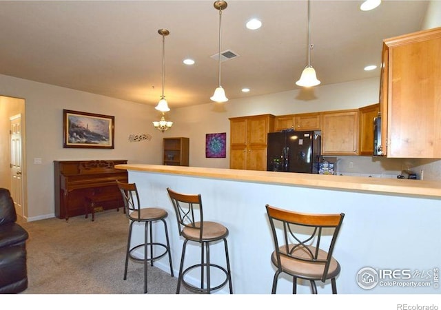 3641 29th St Unit 6, Greeley, CO 80634 - kitchen featuring freestanding refrigerator, recessed lighting, a peninsula, light carpet, and pendant lighting