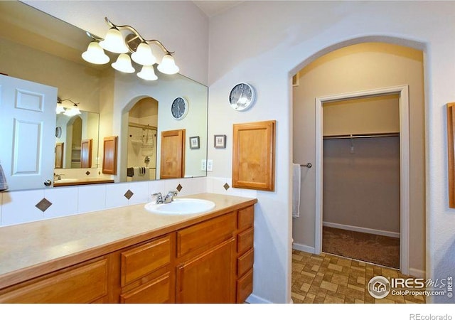 3641 29th St Unit 6, Greeley, CO 80634 - full bathroom with vanity, a spacious closet, a shower, and a chandelier
