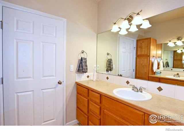 3641 29th St Unit 6, Greeley, CO 80634 - bathroom featuring vanity and a chandelier