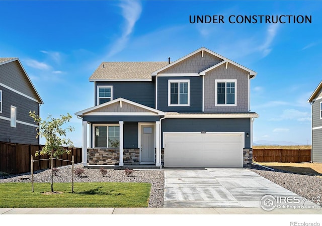 2233 Base St, Fort Lupton, CO 80621 - craftsman inspired home featuring a porch, stone siding, driveway, and an attached garage
