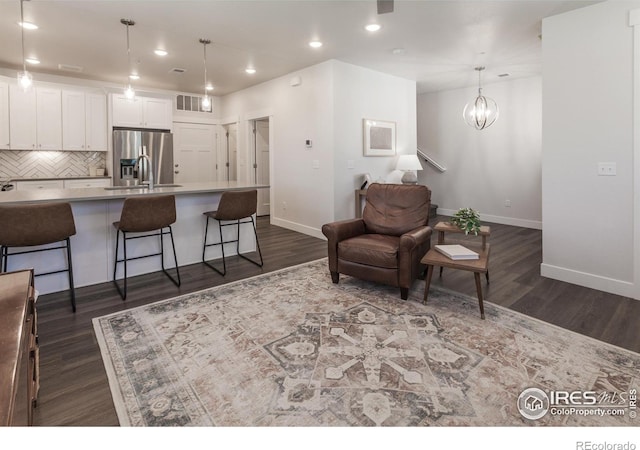 2402 49th Avenue Ct Unit 17, Greeley, CO 80634 - living room with dark wood finished floors, recessed lighting, and a chandelier