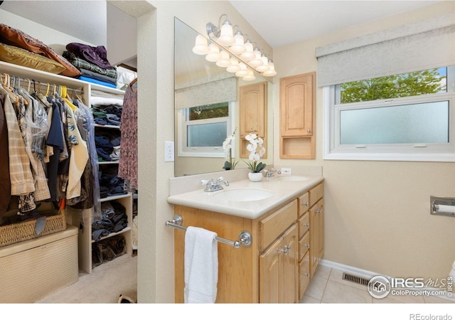 10947 Lynne Ave, Lafayette, CO 80026 - bathroom with double vanity, tile patterned floors, and a spacious closet