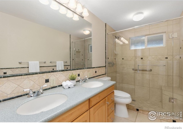 10947 Lynne Ave, Lafayette, CO 80026 - bathroom featuring a shower stall, double vanity, and tile patterned flooring