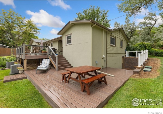 10947 Lynne Ave, Lafayette, CO 80026 - rear view of house featuring stairway, a deck, outdoor dining space, and a yard