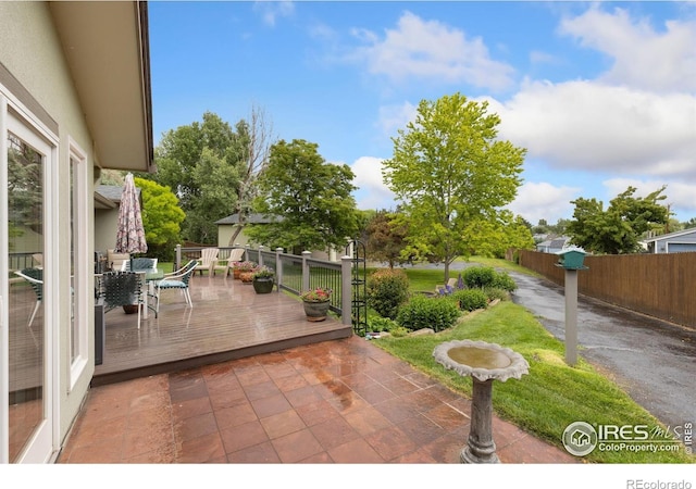 10947 Lynne Ave, Lafayette, CO 80026 - fenced backyard with outdoor dining area, a wooden deck, and a patio