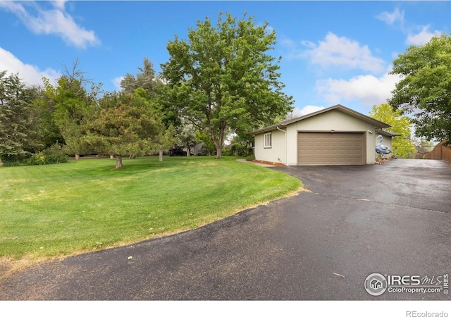 10947 Lynne Ave, Lafayette, CO 80026 - view of front of house with a front yard, an attached garage, and driveway
