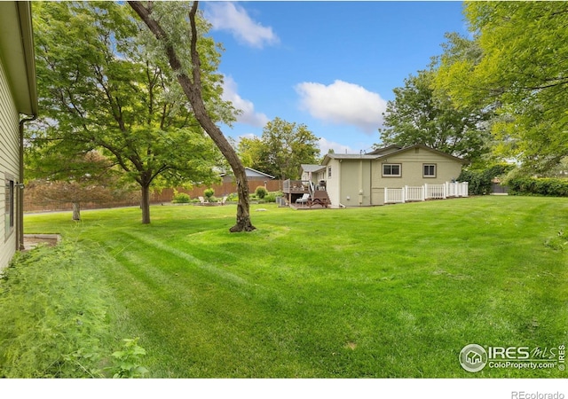 10947 Lynne Ave, Lafayette, CO 80026 - view of green lawn with a wooden deck