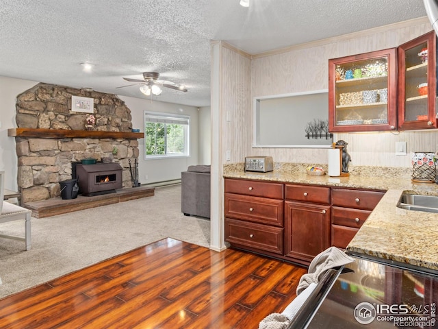 2301 US Highway 34, Drake, CO 80515 - kitchen with a textured ceiling, dark wood-style flooring, ceiling fan, reddish brown cabinets, and light stone counters