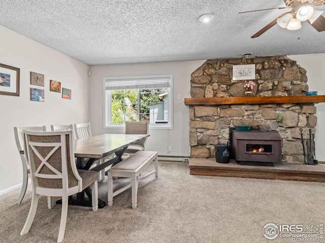 2301 US Highway 34, Drake, CO 80515 - dining area featuring carpet flooring, ceiling fan, a baseboard radiator, a textured ceiling, and a stone fireplace