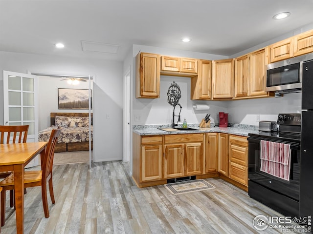 2301 US Highway 34, Drake, CO 80515 - kitchen featuring black / electric stove, stainless steel microwave, light wood-style floors, light stone countertops, and recessed lighting