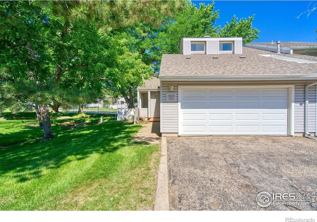 1925 28th Ave Unit 30, Greeley, CO 80634 - view of front of property featuring a garage, a front yard, roof with shingles, and asphalt driveway
