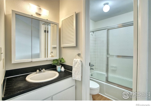 1925 28th Ave Unit 30, Greeley, CO 80634 - full bathroom with vanity, shower / bath combination with glass door, and wood finished floors