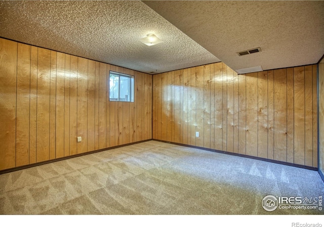 1925 28th Ave Unit 30, Greeley, CO 80634 - carpeted spare room featuring a textured ceiling and wood walls