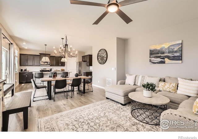 1591 Sun River Rd, Berthoud, CO 80513 - living area featuring light wood-type flooring, a chandelier, and ceiling fan