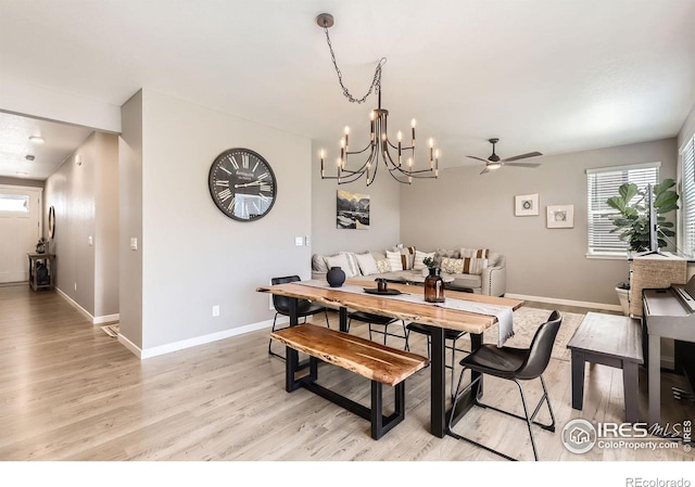 1591 Sun River Rd, Berthoud, CO 80513 - dining area with light wood-style flooring, a chandelier, and a ceiling fan