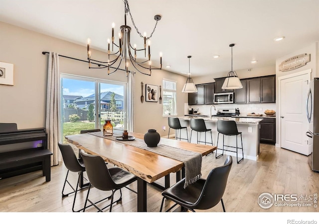 1591 Sun River Rd, Berthoud, CO 80513 - dining room featuring a chandelier, recessed lighting, and light wood-type flooring
