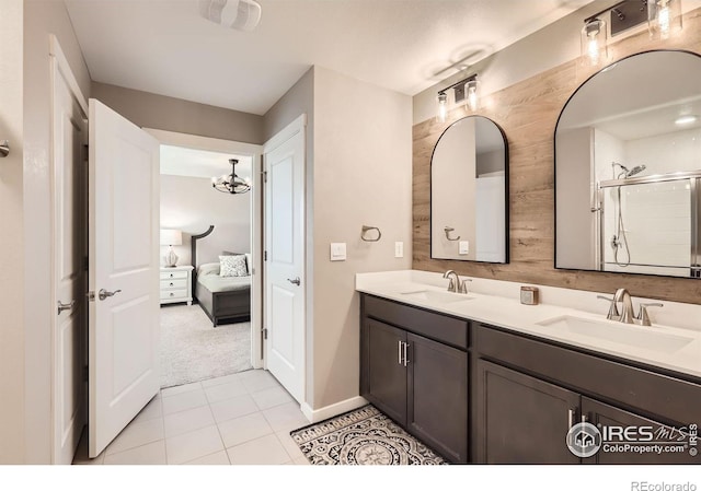 1591 Sun River Rd, Berthoud, CO 80513 - full bath with ensuite bathroom, double vanity, tile patterned flooring, an enclosed shower, and a chandelier