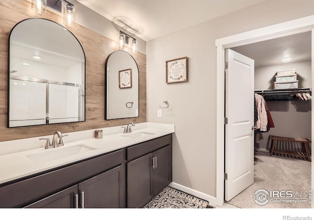 1591 Sun River Rd, Berthoud, CO 80513 - full bathroom featuring double vanity, a spacious closet, and an enclosed shower