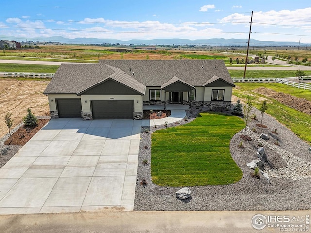 3643 Crested Owl Ct, Dacono, CO 80514 - ranch-style house with stone siding, a garage, and a mountain view