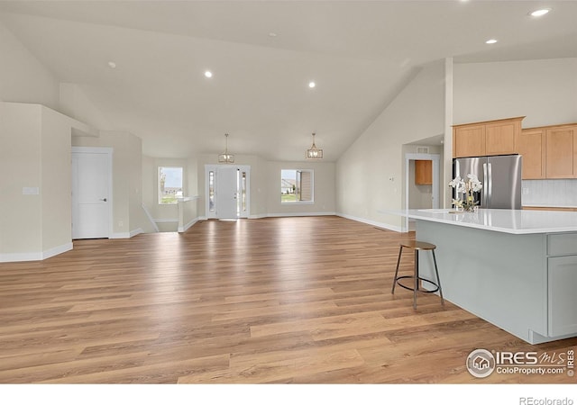 3643 Crested Owl Ct, Dacono, CO 80514 - unfurnished living room featuring light wood-style floors, high vaulted ceiling, and recessed lighting